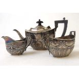 A bachelors silver tea set, Henry Matthews, Birmingham 1907, embossed with ribbons, beads and