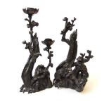 A close pair of Chinese style bronze candlesticks, 19th/20th century, of naturalistic form with a