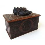 A Victorian chip carved oak candle box, carved throughout with roundels and geometric bands, and a