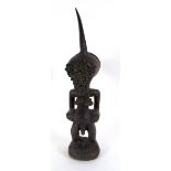 A Songye power figure, Nikisi, Democratic Republic of Congo, with horn charge, the face of copper