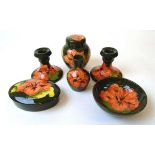 A group of 'Hibiscus' pattern Moorcroft, late 20th century, all on a green ground, impressed