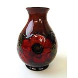 A Walter Moorcroft Flambe Anemone pattern vase, circa 1945 - 49, on a shaded red/blue flambe