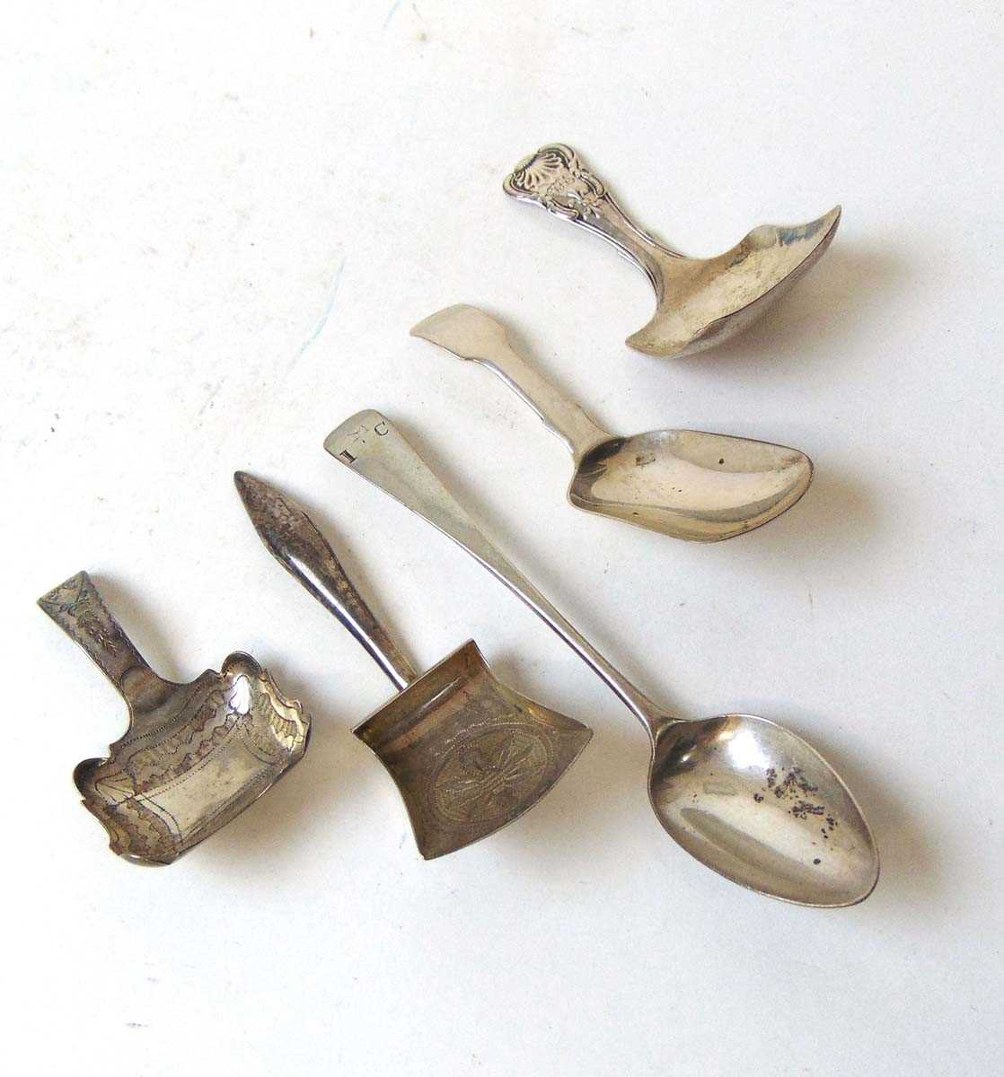 Four early 19th century silver tea caddy spoons, and a Georgian silver teaspoon, various dates and