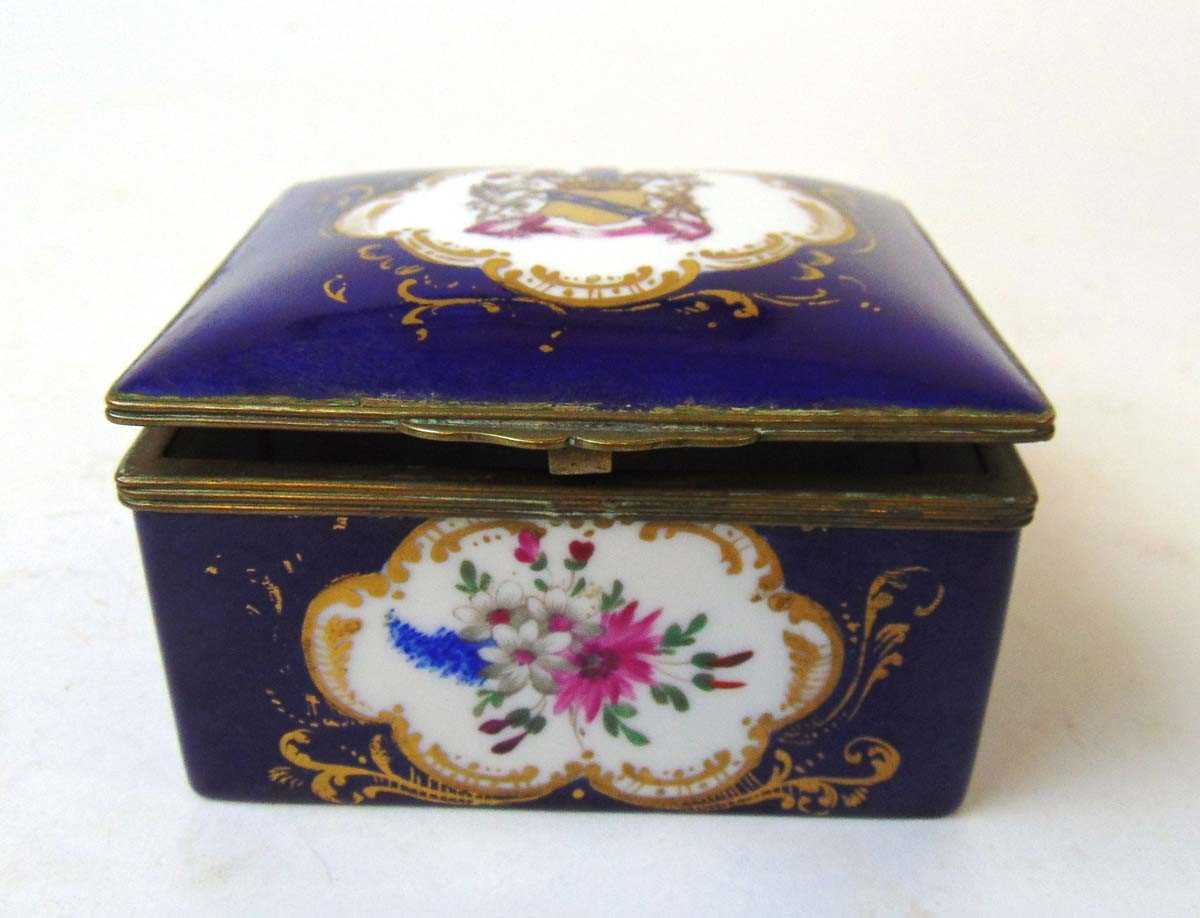 A 19th century French porcelain trinket box, the lid painted with an armorial, the front and rear