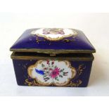 A 19th century French porcelain trinket box, the lid painted with an armorial, the front and rear