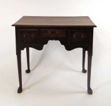 A George III oak lowboy, the top with moulded edge above three short drawers, on straight cabriole