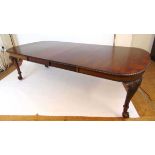 A mahogany extending dining table, early 20th century, with carved gadrooned edge, supported on four