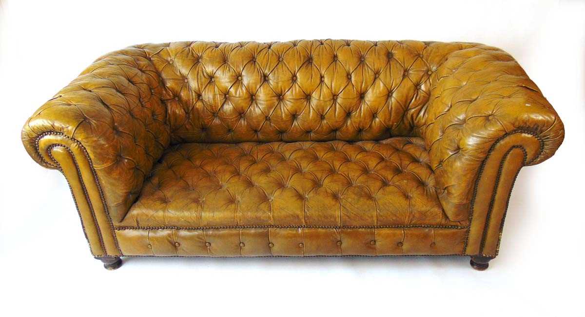 A Victorian green leather upholstered Chesterfield settee, with horsehair and sprung interior, on