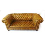 A Victorian green leather upholstered Chesterfield settee, with horsehair and sprung interior, on