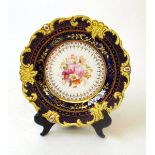 A 19th century English porcelain cabinet plate, with hand painted floral bouquet, within a royal