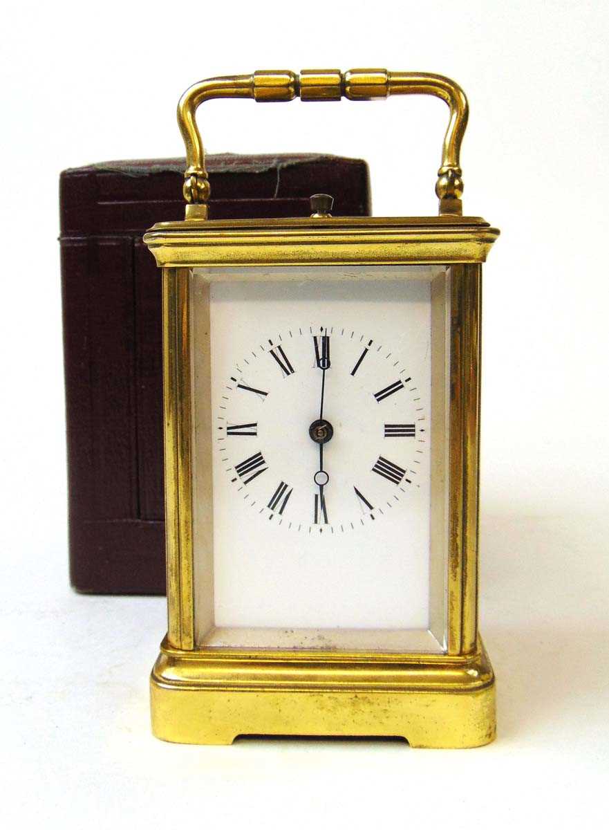 A French brass carriage clock, the eight day movement with repeater action, chiming on a single