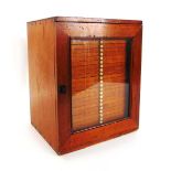 A Victorian collectors cabinet, the stained pine case with glazed door enclosing twenty nine shallow