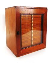 A Victorian collectors cabinet, the stained pine case with glazed door enclosing twenty nine shallow