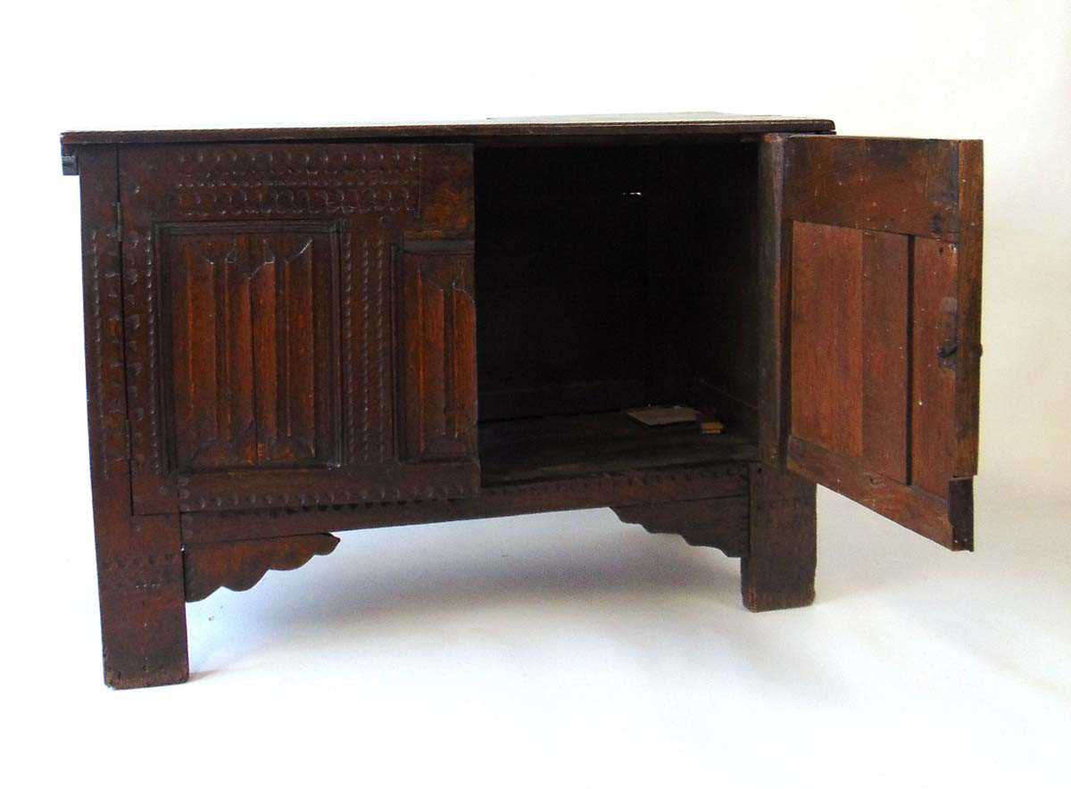 An early 18th century oak blanket box, later converted to a cupboard, with carved linen fold panels, - Image 4 of 4