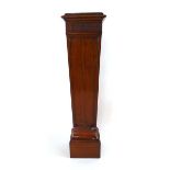 An Edwardian mahogany pedestal, the top with inset red leather panel, above a square tapering body