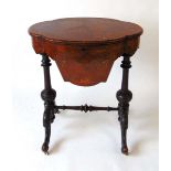 A Victorian walnut work table, the well figured book matched veneered top opening to reveal a fitted
