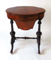 A Victorian walnut work table, the well figured book matched veneered top opening to reveal a fitted