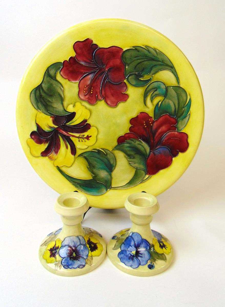 A large Walter Moorcroft hibiscus pattern charger and a pair of pansy pattern dressing table