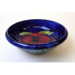 A William Moorcroft Pansy pattern fruit bowl, early to mid 20th century, on a cobalt blue ground,