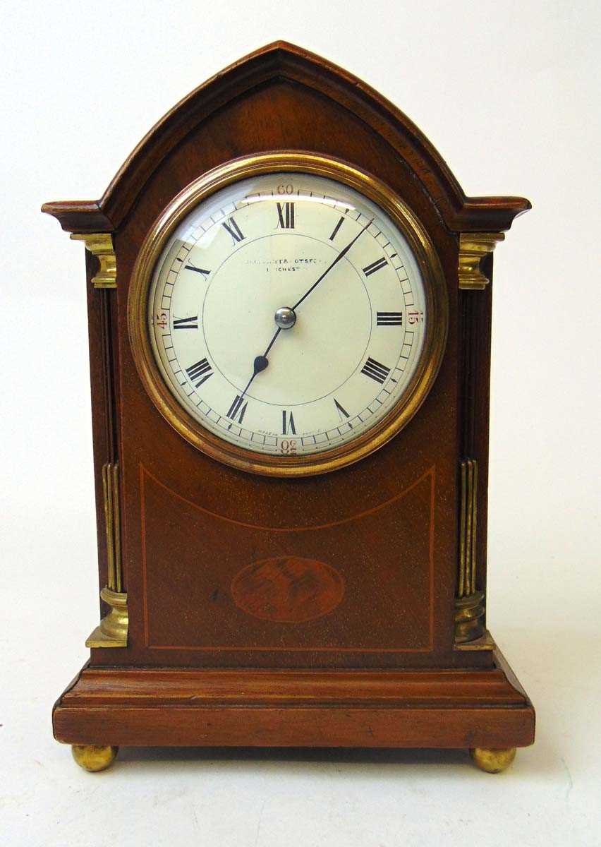 An early 20th century mahogany and inlaid mantel clock, retailed by Ollivant & Botsford, Manchester,