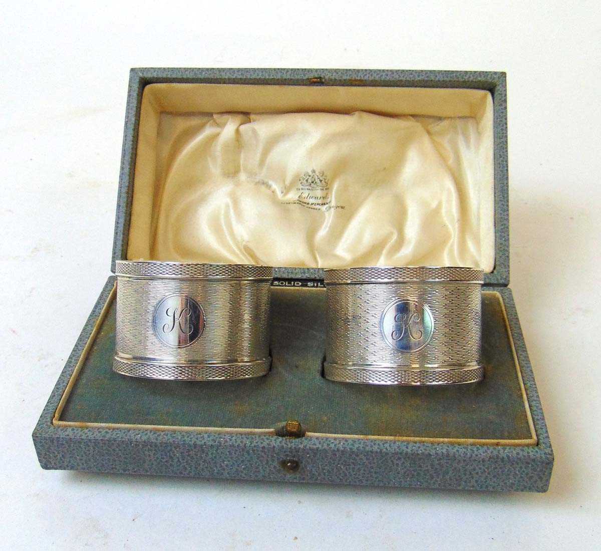 A pair of silver napkin rings, Colen Hewer Cheshire, Chester 1922, with cartouche initialed 'K',