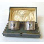 A pair of silver napkin rings, Colen Hewer Cheshire, Chester 1922, with cartouche initialed 'K',