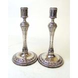 A pair of late Victorian classical revival silver candlesticks, one struck for George Howson 1894,