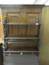 A set of mahogany wall hanging shelves with three trinket drawers to base