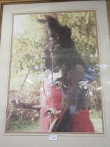 A framed and glazed limited edition print of African people, number 264/850 ,signed Combes