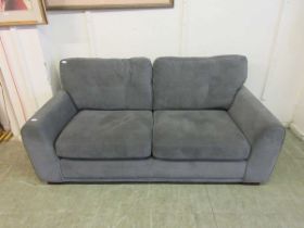 A modern grey upholstered two seater settee