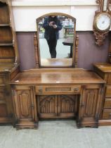 A mid-20th century dressing chest having swing mirror to back, the base having a centre drawer above