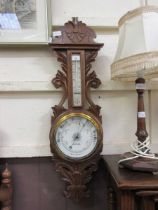 A late Victorian carved oak banjo barometer by R.Gilbert and Sons of Conventry and Barlow