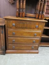 A mid-20th century oak chest of four drawers with a linen fold design