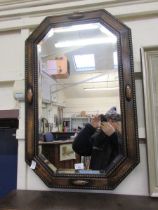 An oak octagonal framed bevel glass wall mirror