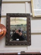 A carved oak bevel glass wall mirror