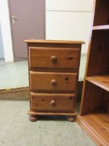 A pine bedside chest of three drawers