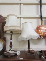 Two early 20th century carved wooden table lamps with shades