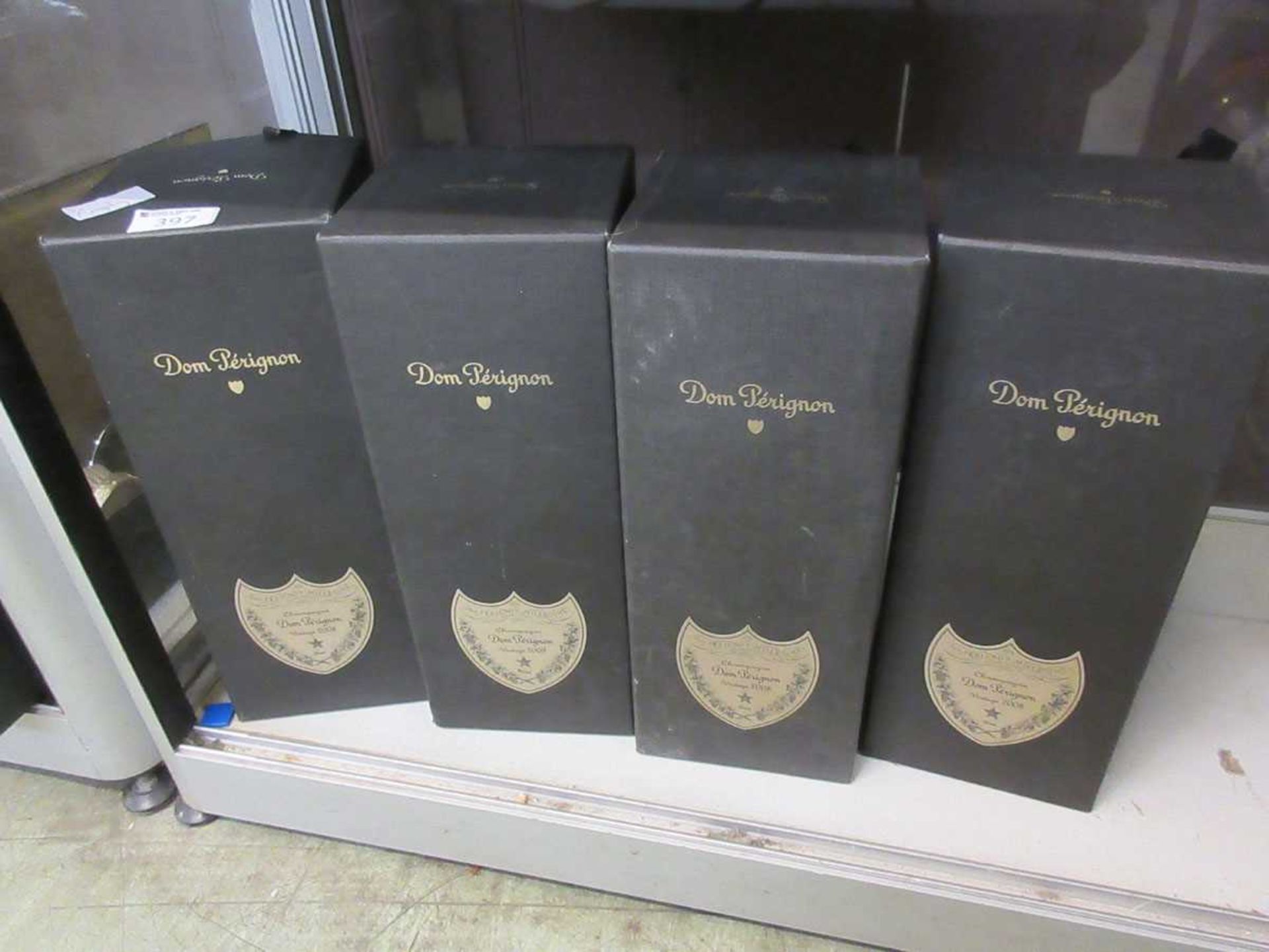 Four empty Dom Perignon champagne boxes