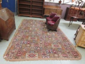 A mid 20th century machine made patterned rug, with rounded corners and fringe