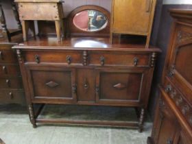 A mid-20th century mirror backed sideboard having oval mirror to back, the base having two drawers