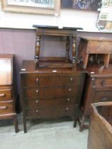 A mid-20th century oak veneered chest of four drawers