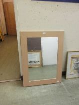 A laminated framed wall mirror