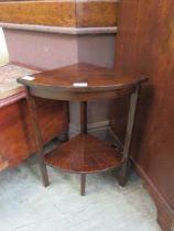 A mid 20th century oak quarter occasional table with under tier