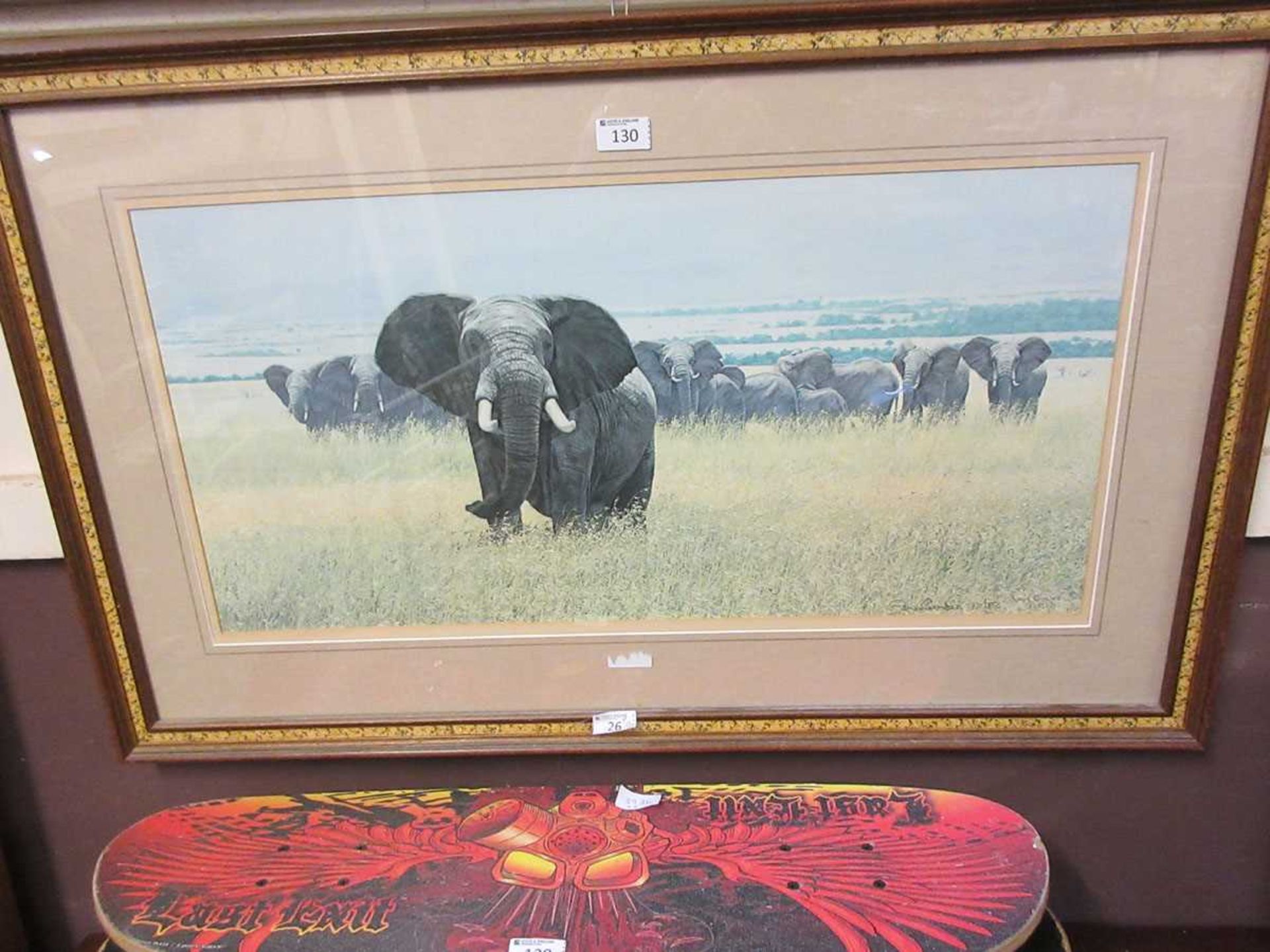 A framed and glazed limited edition print of herd of elephants number 170/850 signed Simon Combes