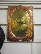 A brass and and copper hammered wall plaque