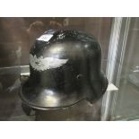 A military style helmet, possibly German Mark inprinted to inner front of helmet reads: