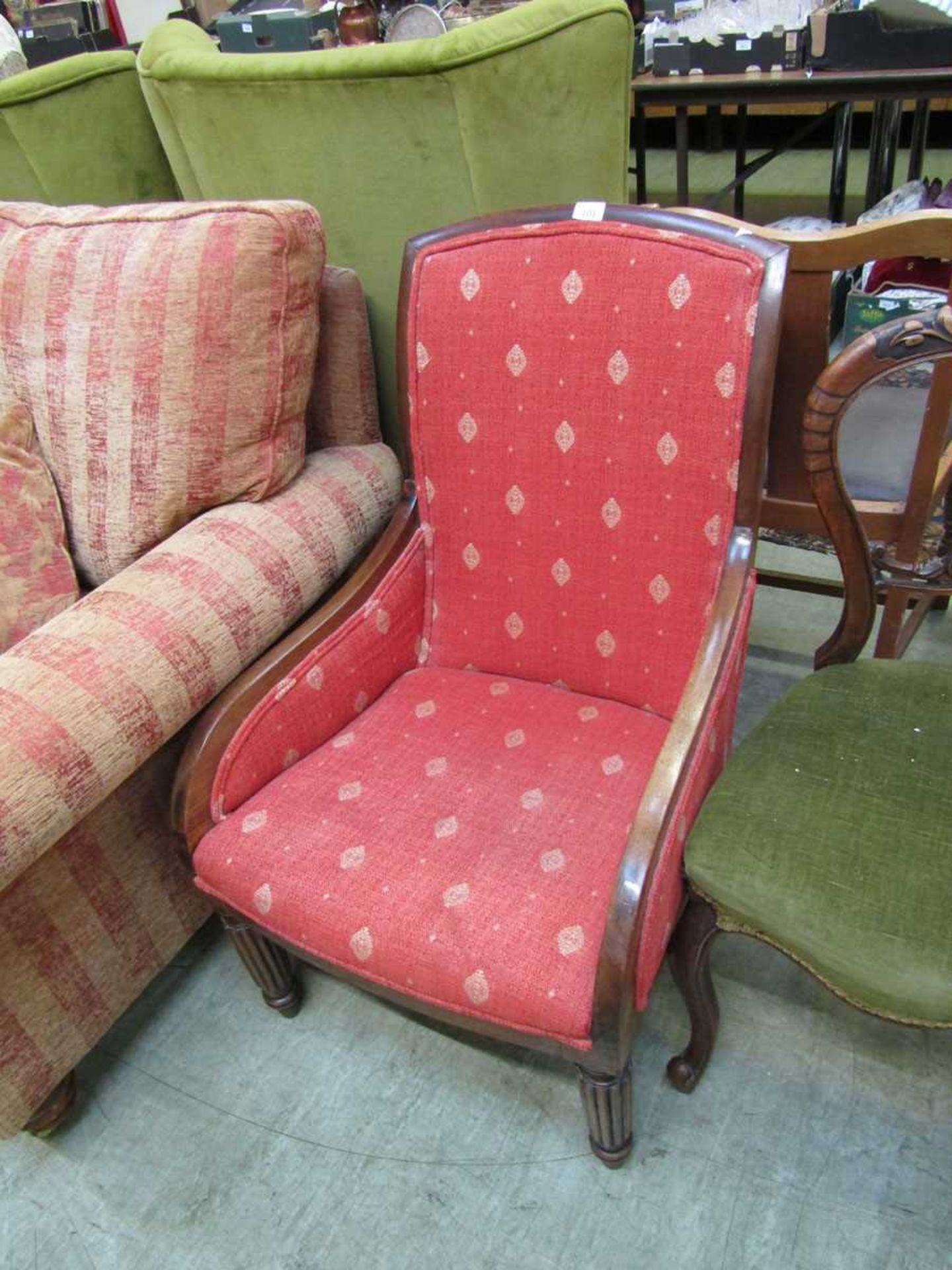 A William IV mahogany framed easy chair upholstered in salmon pink