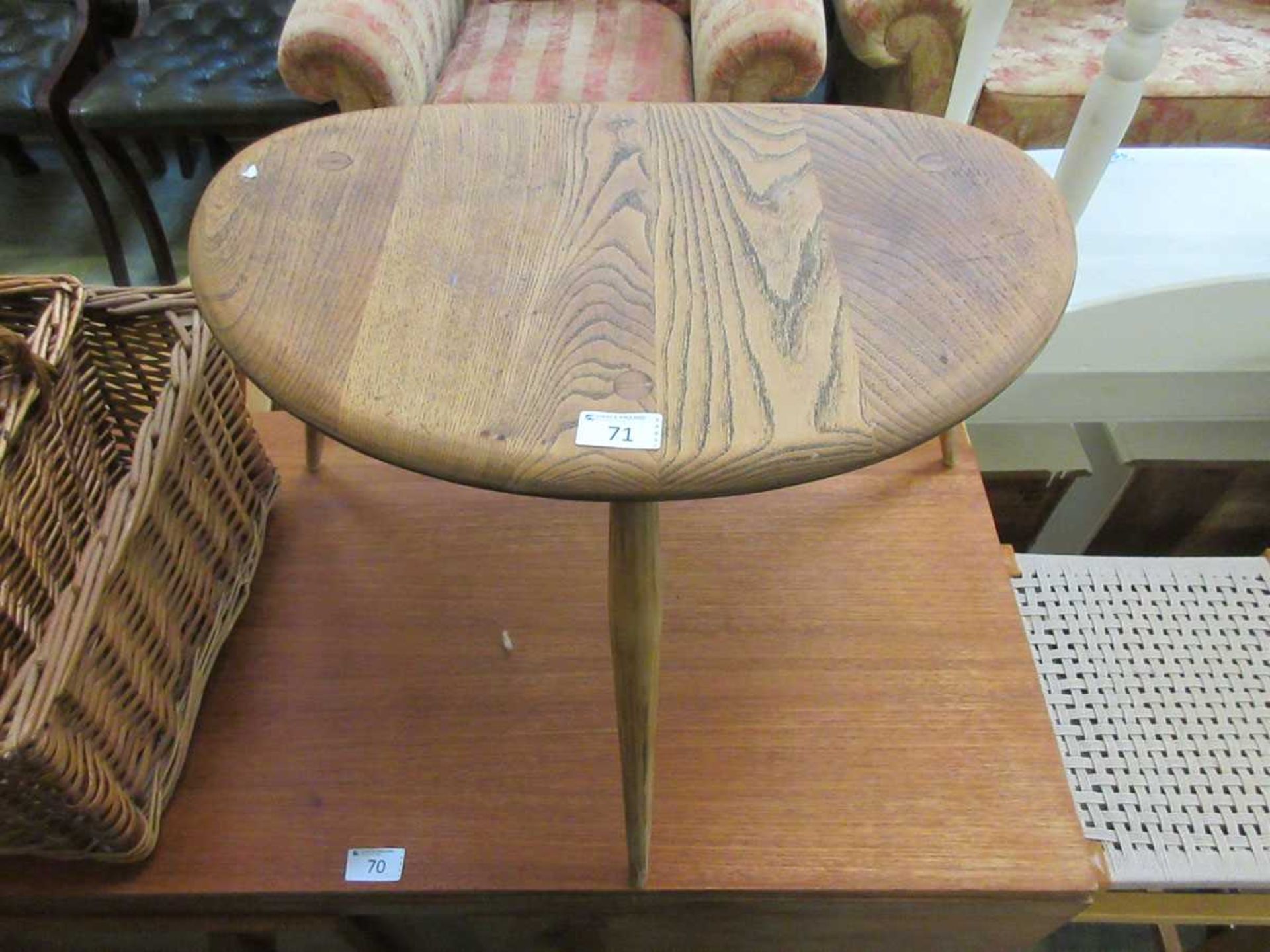 An Ercol style elm three legged stool