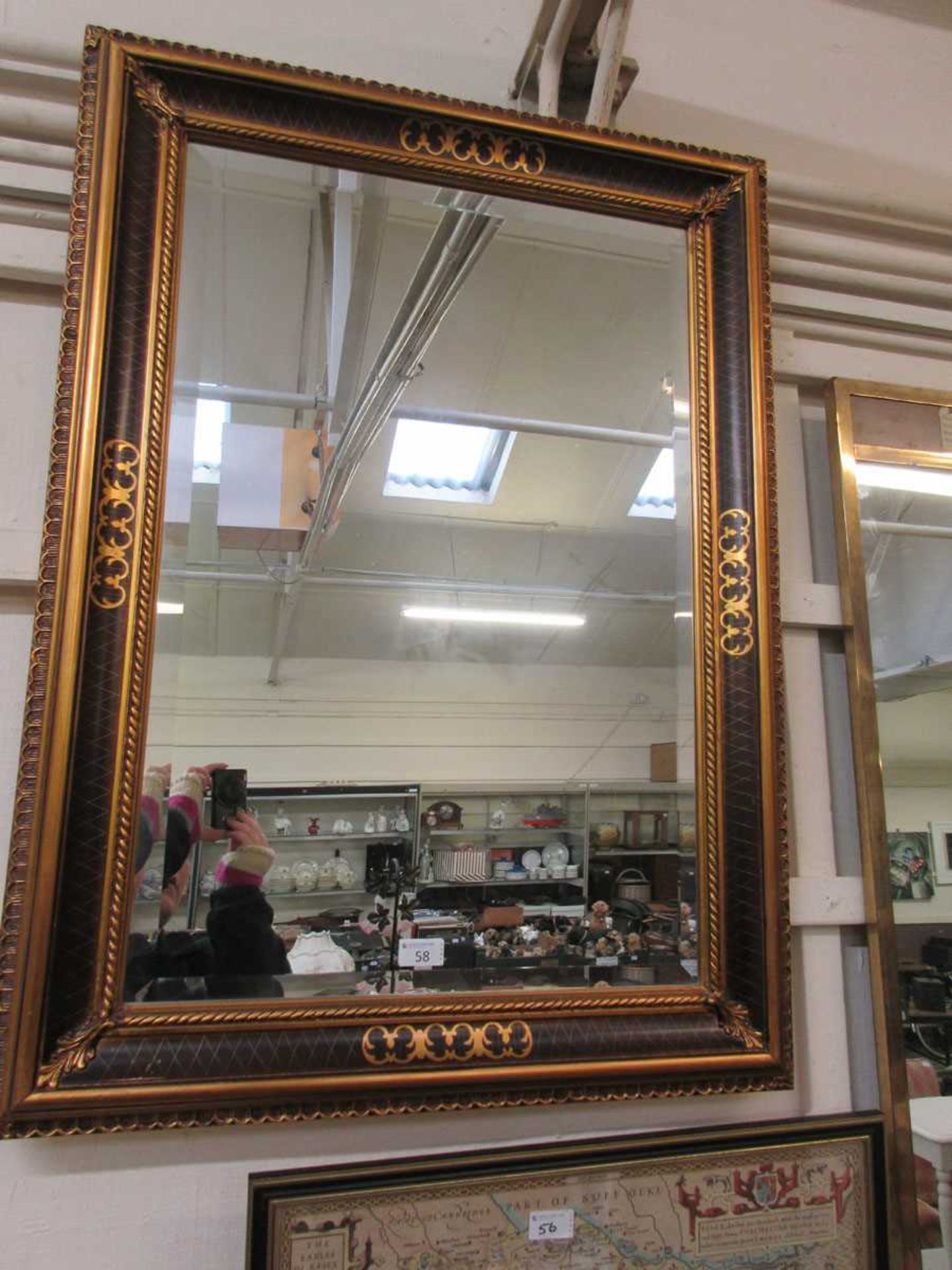 A large modern and gilt framed rectangular wall mirror