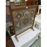 A mahogany framed framed fire screen, with crewel work panel